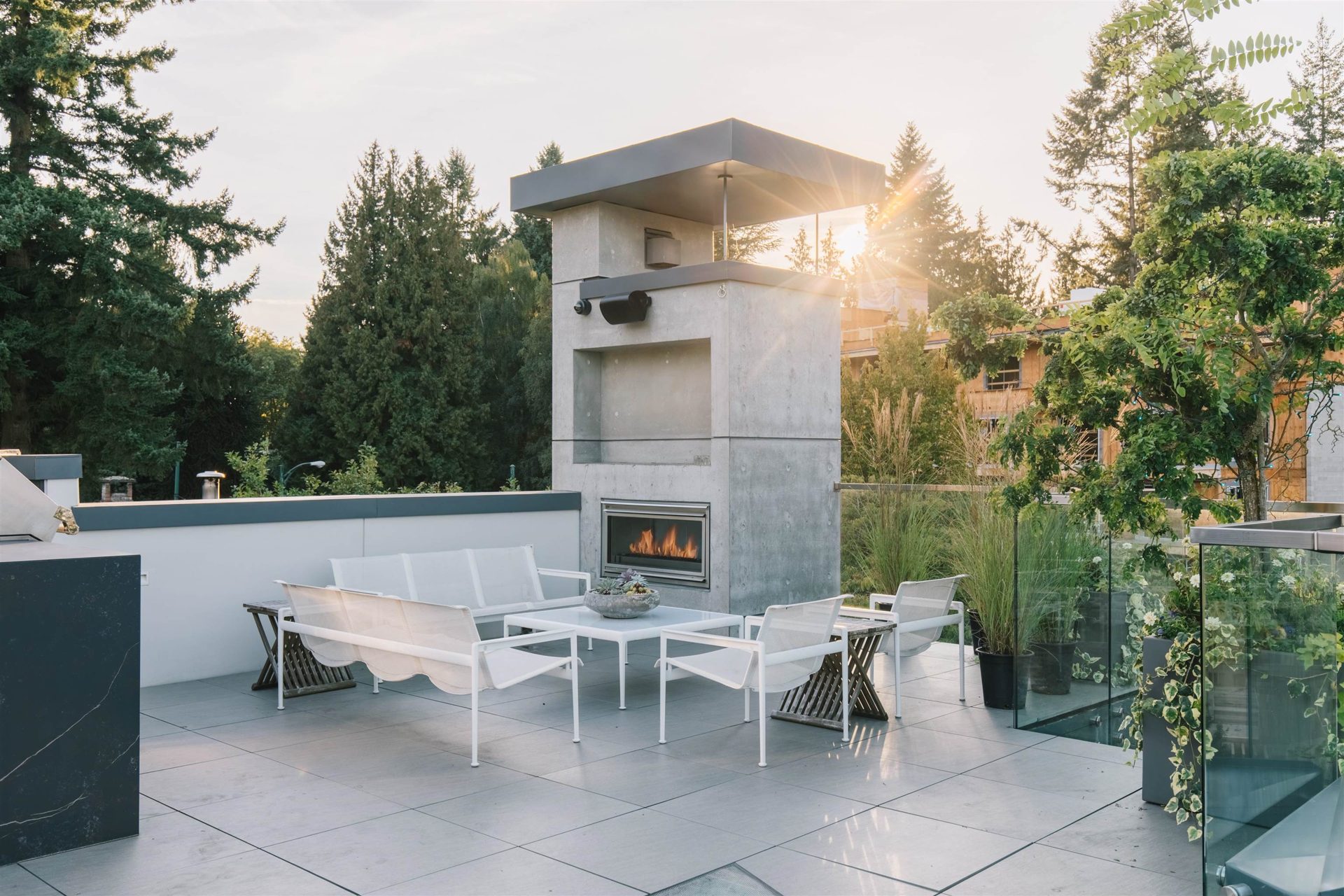 Terrace with outdoor fireplace at last light